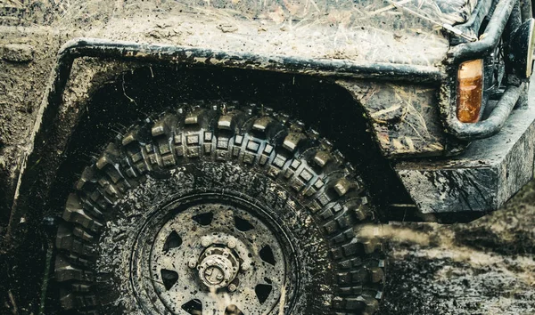 Forget about driving on smooth tarmac. Car racing offroad. Offroad car in action. Dirty car drive on high speed. SUV or offroader on mud road. Car wheels on steppe terrain splashing with dirt — Stock Photo, Image