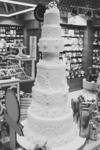 Wedding cake decorated with flowers in bakery