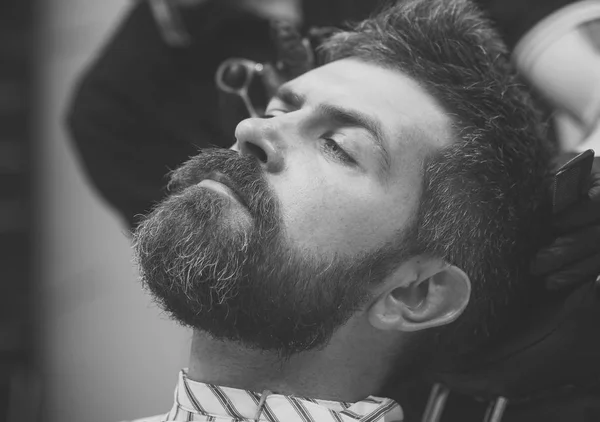 Man getting hair cut at barbershop