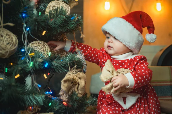 Weihnachtsbabys. Weihnachtskinder. Niedliche kleine Kind schmückt Weihnachtsbaum drinnen. Glückliche Kinder. — Stockfoto