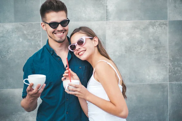 Coffee is ideal for conversation. Couple of woman and man with coffee cups. Girlfriend and boyfriend have espresso or latter drink. Couple in love drink coffee outdoor. Enjoying the best coffee date