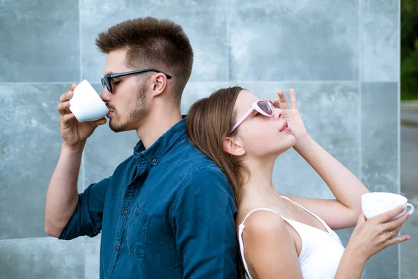 Stop and smell the coffee. Couple of woman and man with coffee cups. Enjoying the best coffee date. Couple in love drink coffee outdoor. Girlfriend and boyfriend have espresso or latter drink