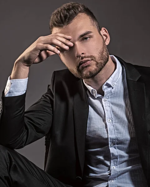 Business style. Confident and successful. Handsome young man in a business suit. Elegant handsome business man isolated on black. Closeup bearded businessman wearing stylish mens suit.