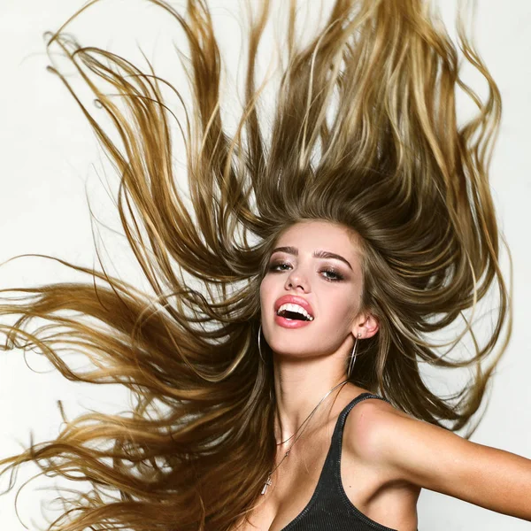 Perfect long hair. Blonde wave long hair. Perfect girl smiling on white background. Beauty and perfect health hair. Beauty model with perfect clean skin. Long hair.
