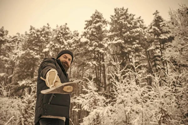 Bebaarde man met bijl in het besneeuwde forest. — Stockfoto