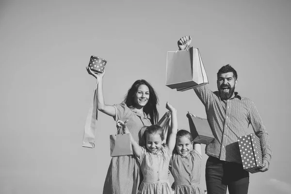 Man, woman and children with gifts on sky background — Stock Photo, Image