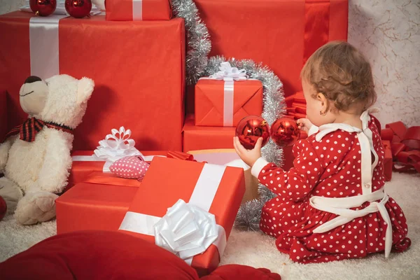 Cute baby with gift. Child with a present gift. Holiday babies concept.