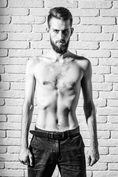 Slim bearded man with thin bare torso on brick background — Stock Photo, Image