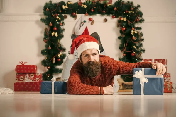 Christmas man with beard on happy face at present box.