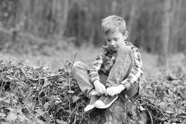 促进儿童发展。小男孩在树林里放松。小男孩培养身体能力。把儿童的成长和发展放在首位, 黑白 — 图库照片