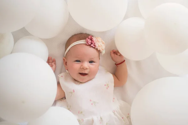 Tiny hand. Family. Child care. Childrens day. Small girl. Happy birthday. Sweet little baby. New life and birth. Portrait of happy little child in white balloons. Childhood happiness — Stock Photo, Image