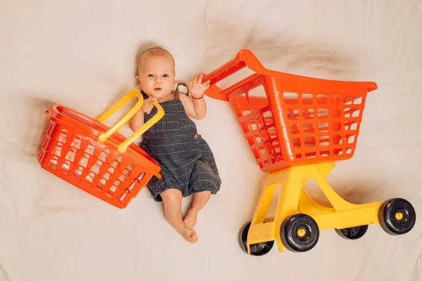 Hungry baby. Sweet little baby. New life and birth. Small girl go shopping. Shopping cart. Householder. Family. Child care. Portrait of happy little child. Childhood happiness. Big sale offer