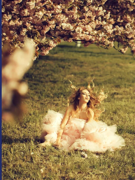 Sinnliche Frau auf Gras mit Blüte — Stockfoto