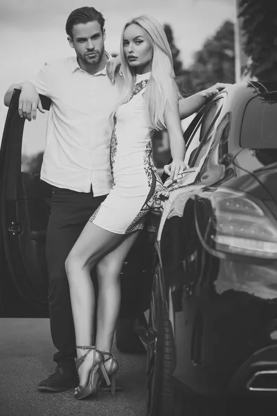 Sexy couple at car on summer day