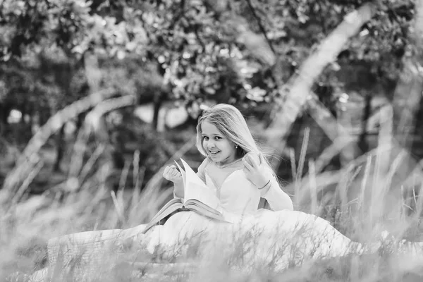 Niña en vestido con cesta de frutas y libro — Foto de Stock