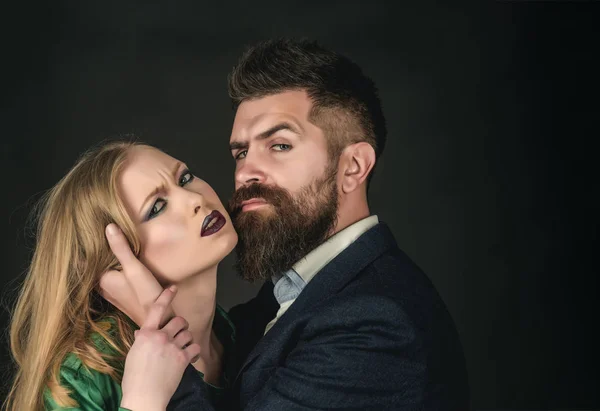 They both love fashion. Intimate couple in fashion clothing. Couple in love. Bearded man hug woman with long hair. Fashion style and hair care. Style icons. Say I love you often — Stock Image They both love fashion. Intimate couple in fashion clothing. Couple in love. Bearded man hug woman with long hair. Fashion style and hair care. Style icons. Say I love you often Royalty Free Stock Images