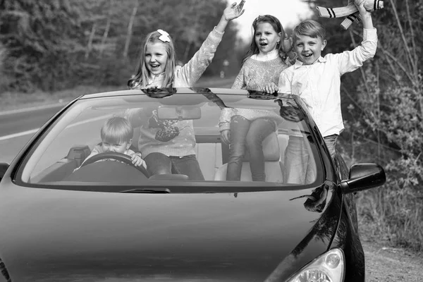 Happy children friends in car — Stock Photo, Image