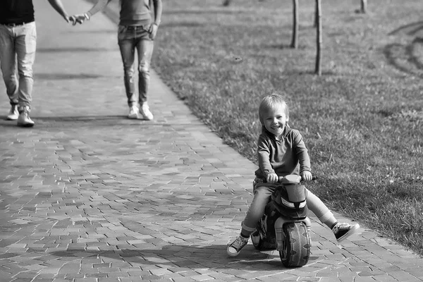 Happy boy on toy bike — Stock Photo, Image