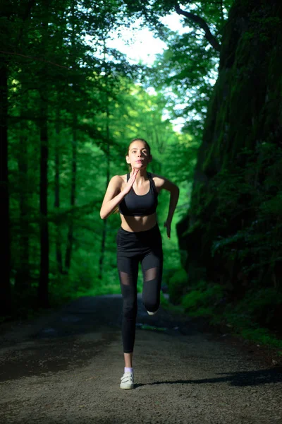 Run to success. Sport and sportswear fashion. Sport success. Fitness woman with good athlete body. fit your body and lose weight. Healthy lifestyle concept. sporty woman training in green forest