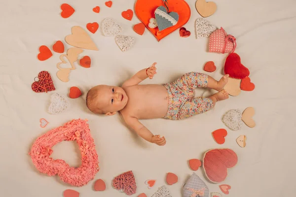 You are my heart. Love. Portrait of happy little child. Sweet little baby. New life and birth. Family. Child care. Small girl among red hearts. Childhood happiness.Valentines day — Stock Photo, Image