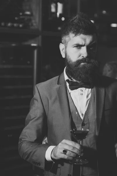 Date meeting of hipster awaiting in pub. bar customer sit in cafe drinking alcohol. Businessman with long beard drink in cigar club. Perfect wine. Bearded man rest in restaurant with wine glass. — Stock Photo, Image