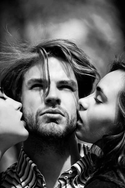 Человек, получающий поцелуй от двух восхитительных девушек — стоковое фото