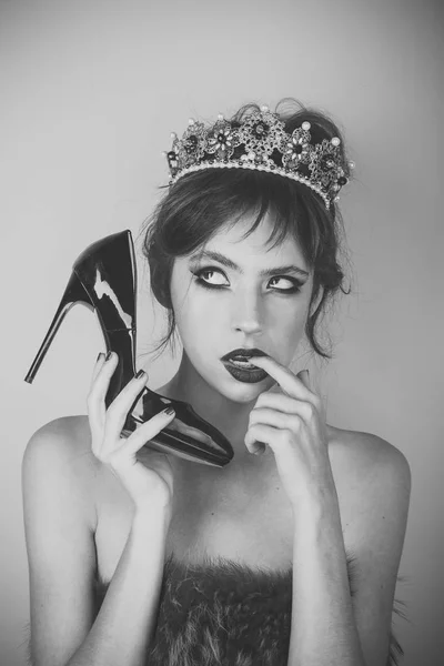 Luxury of woman in crown jewelry and shoe as phone. Makeup for woman with soft skin. Communication and fetish, hairdresser. Beauty queen and fashion. Fashion girl with elegant look and makeup.