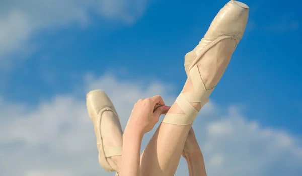 Accentuating the beauty. Ballet slippers. Ballerina shoes. Ballerina legs in ballet shoes. Feet in pointe shoes. Pointe shoes worn by ballet dancer. Classic dance style. Concert dance performance