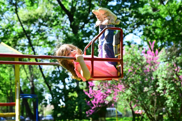 Romantic little girl on the swing, sweet dreams. Small kid playing in summer. childhood daydream .teen freedom. Playground in park. Happy laughing child girl on swing. Happy spring day — Stock Photo, Image