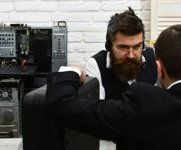 Making a deal. Company manager and man have business meeting. Customer hold briefcase. Bearded man listen to customer. Businessmen at office desk. Business negotiations