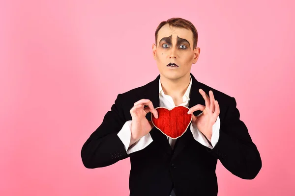 In love again and always. Mime man hold red heart for valentines day. Mime actor with love symbol. Theatre actor pantomime falling in love. Love confession on valentines day