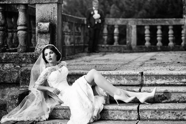 Bride sitting on stairs