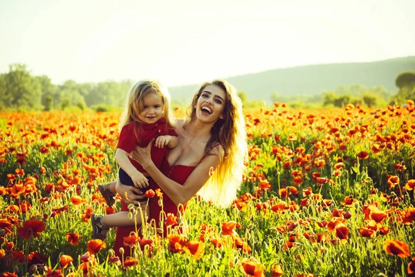 Mothers day, girl and little boy in field of poppy — Stock Photo, Image