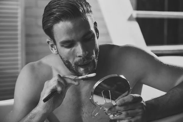 Macho with shaving soap on beard hair look in mirror — Stock Photo, Image