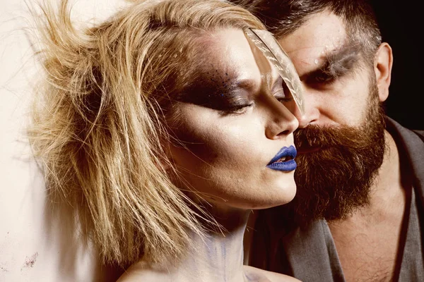 Makeup couple. Sensual woman and bearded man with makeup and stylish hair. We makeup your face. Makeup and beauty