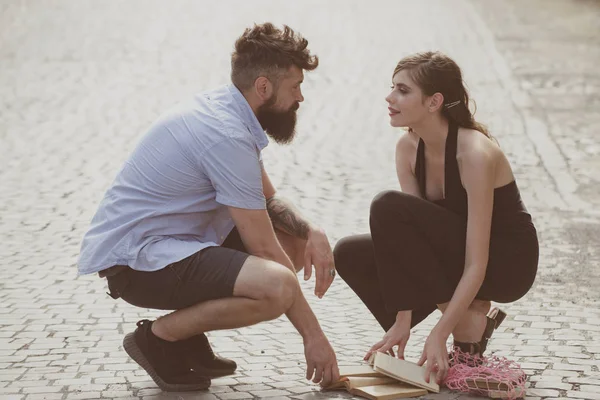 Love at first sight. Man and woman falling in love. Bearded man and cute woman met on street. Hipster helping and looking at pretty girl. Couple in love on summer day. Enjoy romantic date and dating — Stock Photo, Image