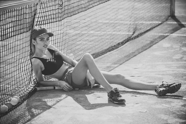 Girl on tennis court on beautiful sunny day