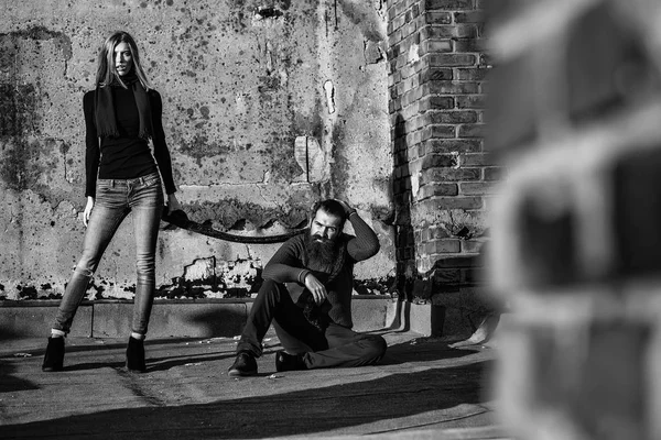 Young couple near roof brick wall