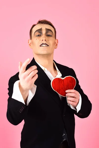 Performing love on stage. Theatre actor pantomime falling in love. Mime man hold red heart for valentines day. Mime actor with love symbol. Love confession on valentines day