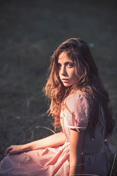 Woman with no makeup relax on grass in vintage style. Beauty girl with long brunette hair. Fashion model in retro dress outdoor. Summer vacation concept. Camping, travel and wanderlust — Stock Photo, Image