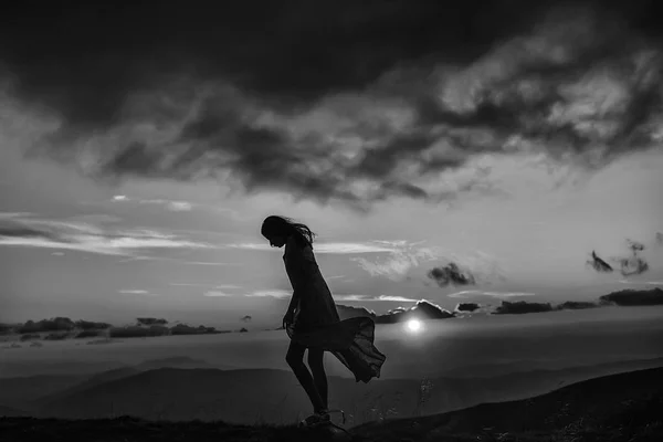 Woman at sunset or sunrise in mountains — Stock Photo, Image