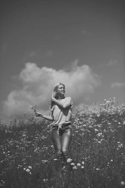 Sensual woman in blossoming flower field, spring.