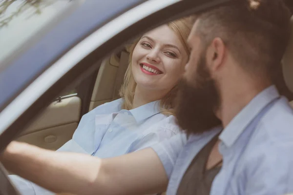 Eco transportation. Couple in love travel by automobile transport. Loving couple enjoy sustainable travel. Bearded man and sexy woman driving car. Using sustainable transport for zero pollution