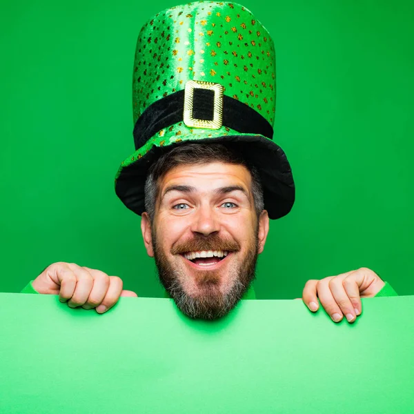 Lucky Patricks day. Man on green background celebrate St Patricks Day. Man in Saint Patricks Day leprechaun party hat having fun on green background. Copy space.