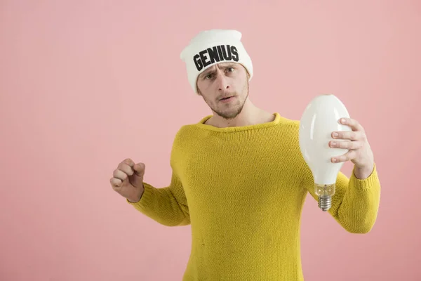 Being creative. Handsome man wearing hat with genius word. Serious man hold light bulb. Boy genius got bright idea. A genius idea came into her head. Oh, I am genius