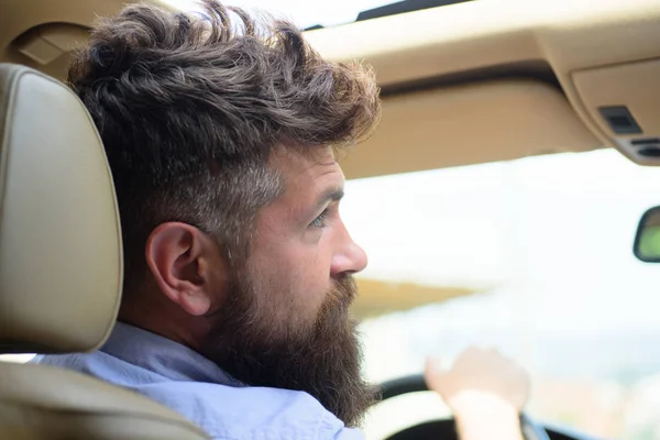 Green tech. Bearded man travel by automobile transport. Hipster enjoying road trip. Eco driving is an ecologic driving style. Eco friendly and sustainable travel. Travelling by road transport