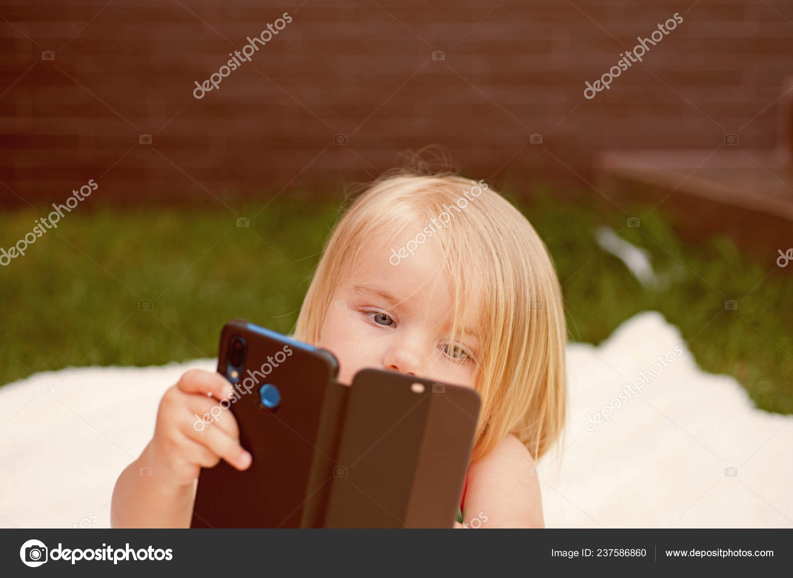 I see you. New technology for children. Small child make video call with  smartphone. Small girl with mobile phone. Girl child with blond hair talk  on cell phone. Natural hair care Stock