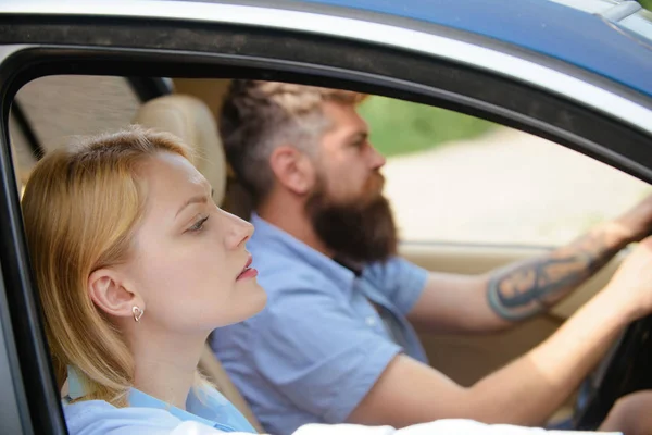 Save the environment. Sexy woman and bearded man go by car. Couple in love travel by automobile transport. Loving couple enjoy sustainable travel. Using sustainable transport for zero pollution