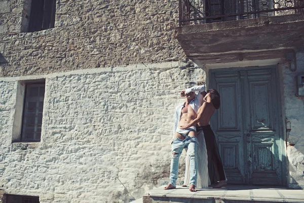 Fashion couple with sexy body at house. fashion woman and man have romantic relations near house, copy space.