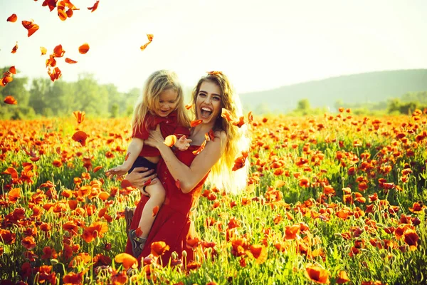 Love and family, happy mother and child in poppy field — Stock Photo, Image
